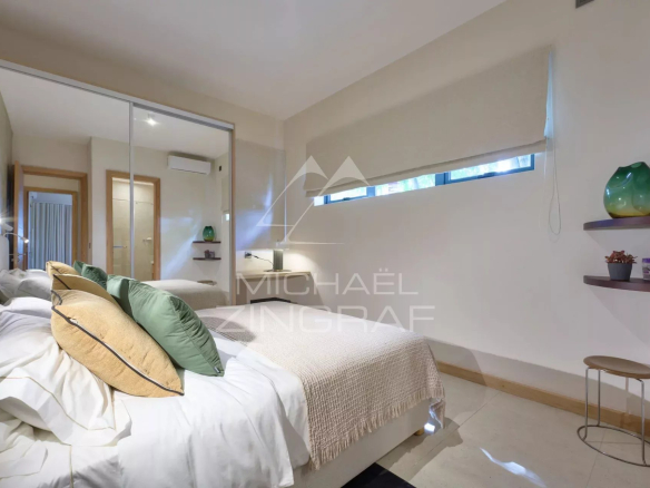 Elegant apartment room with bed and modern decor in Belle Vue Harel.