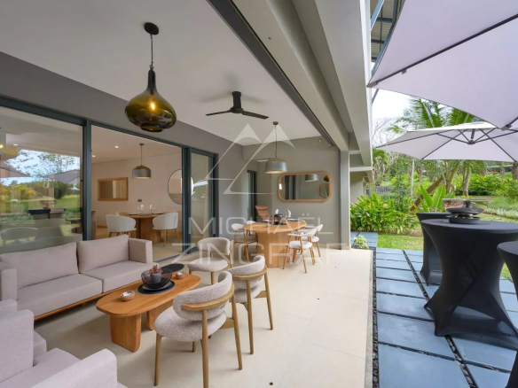 Apartment terrace with modern furniture, overlooking a green garden in Belle Vue.