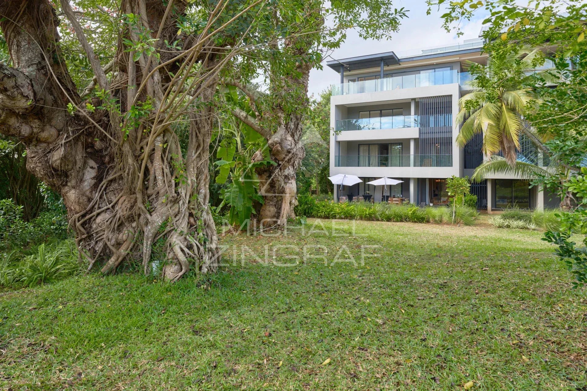 View of a modern apartment with private garden and trees in Belle Vue Harel.