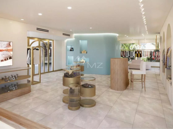 Interior of an elegant boutique with clothes on display and modern furniture.