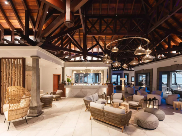 Interior of a luxury villa with a modern design and wooden ceiling, comfortable furniture and elegant lighting.