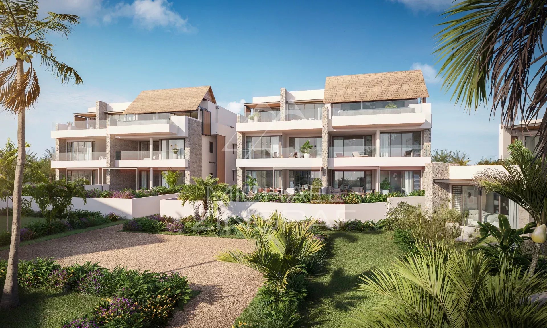 Exterior view of a luxury penthouse in a 5-star resort in Wolmar, surrounded by vegetation.