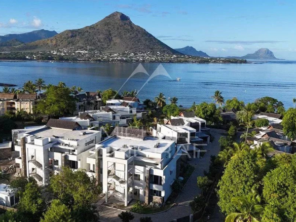 Aerial view of a penthouse in a resort in Wolmar, with swimming pool and view of Le Morne Brabant.