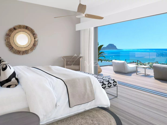 Chambre d'une villa avec vue sur la mer, lit double et accès à une terrasse.