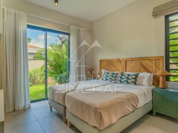 Chambre d'une villa contemporaine avec lit double et vue sur le jardin à Tamarin.
