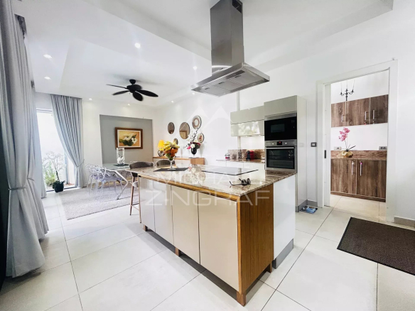 Interior of a modern villa with open kitchen and bright living room in Pereybère.