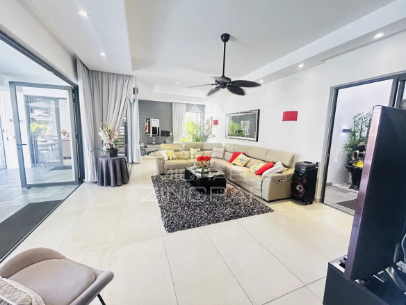 Interior of a modern villa in Pereybère with a bright living room and comfortable furniture.