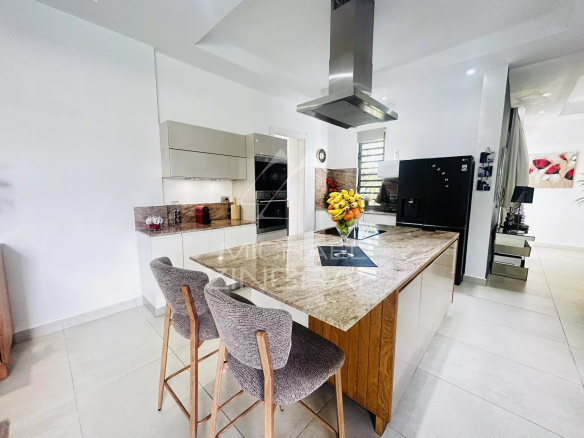Modern kitchen with a central island in a villa in Pereybère, Mauritius.