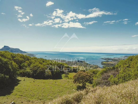Panoramic view of the lagoon and nature at Pointe d'Esny, with hills in the background.