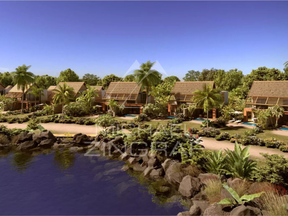 View of a duplex in Pointe d'Esny with swimming pool and garden, surrounded by nature and ponds.