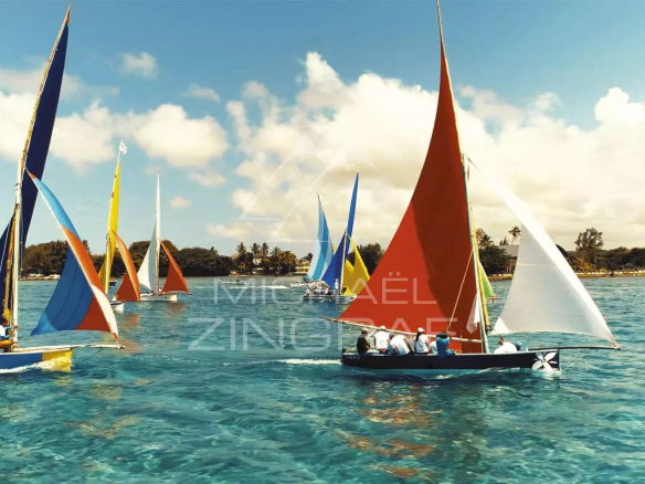 Colorful sailboats sailing on a turquoise lagoon at Pointe d'Esny