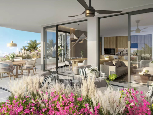 Terrace of a modern apartment with plants and elegant furniture, overlooking a tropical garden.