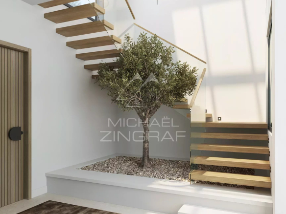 Modern staircase with glass railing and tree in a bright interior space.