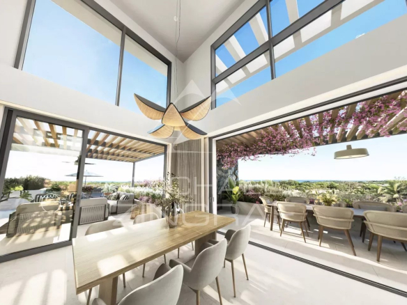 Interior of a modern penthouse with dining room and views of a tropical garden in Balaclava.