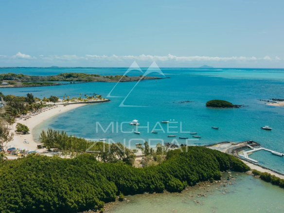 Aerial view of the sea and beach at Haute Rive, with islets and boats.