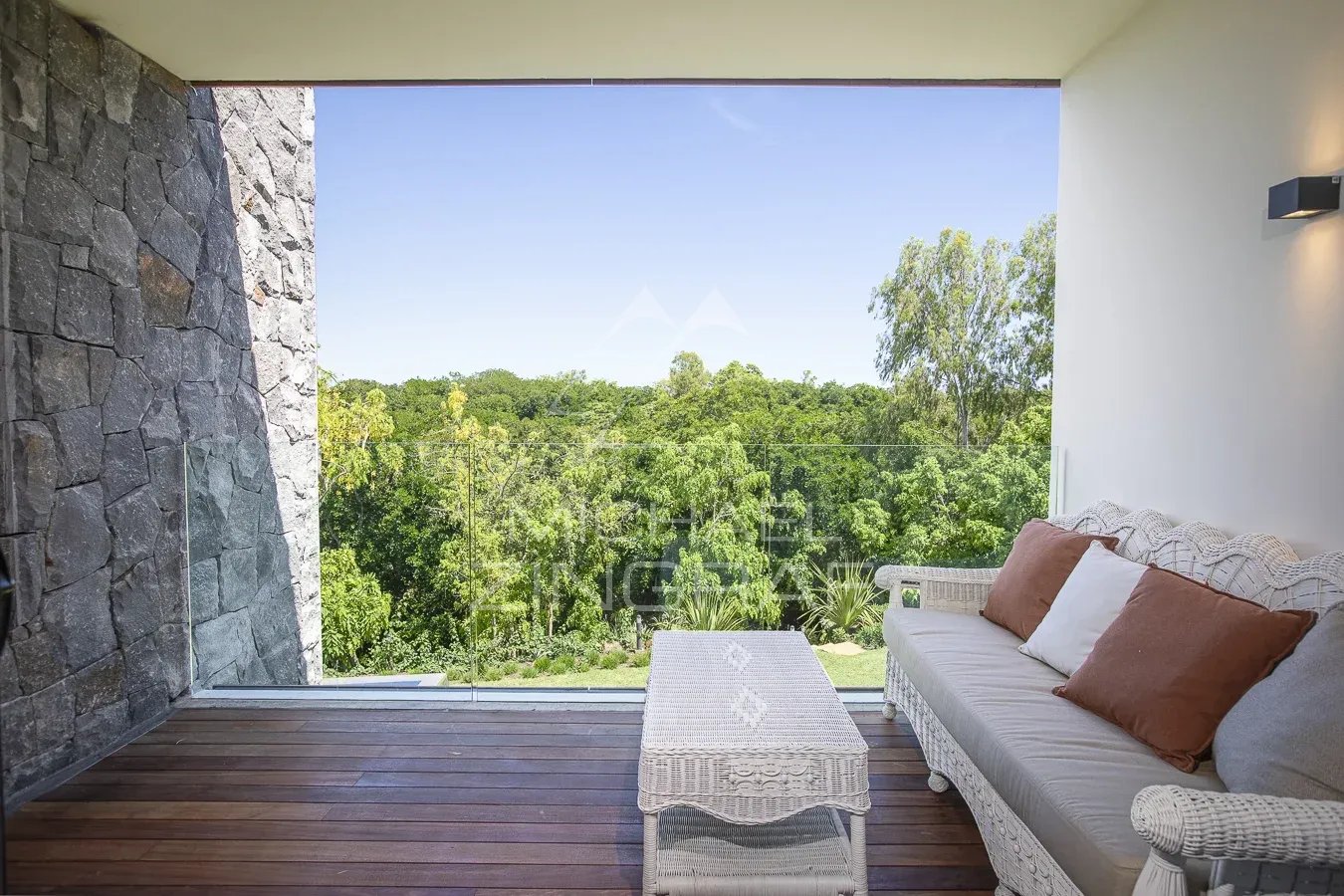 Villa terrace in Haute Rive Terrace of a villa with views of the vegetation, wicker furniture, and natural light.