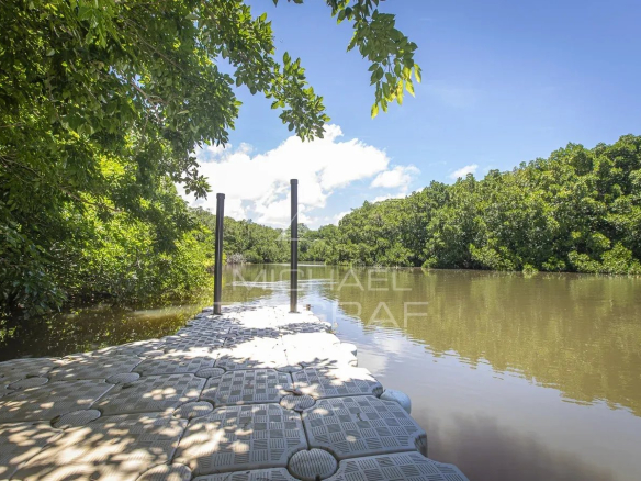 Quay on the river surrounded by greenery in Haute Rive, Azuri