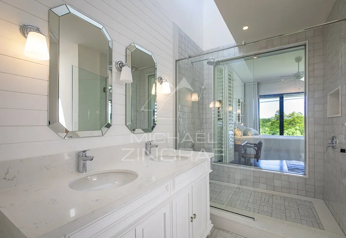 Luxury villa bathroom Modern bathroom with double sink and glass shower in a luxury villa.