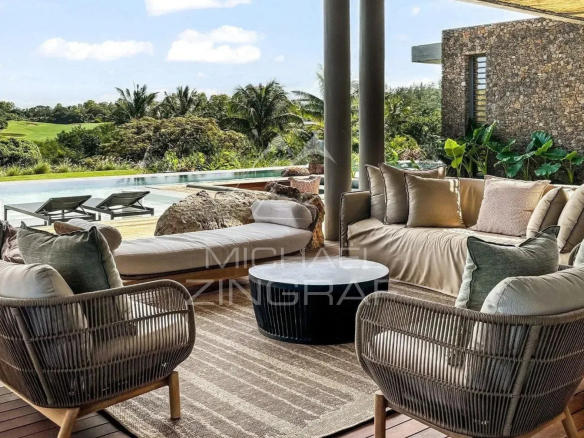 Terrace of a contemporary villa with garden furniture and a view of the golf course.