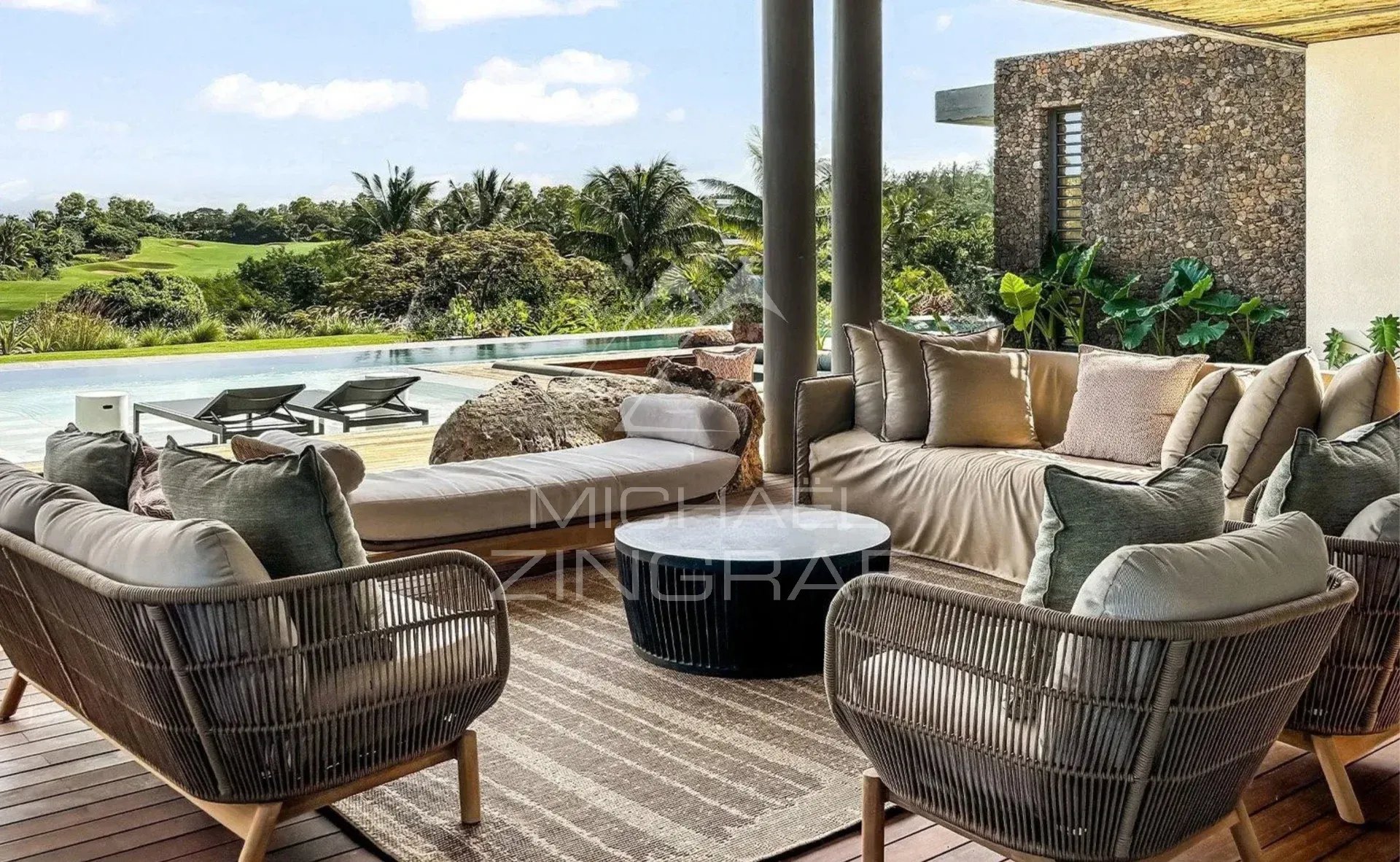 Terrace of a contemporary villa with garden furniture and a view of the golf course.