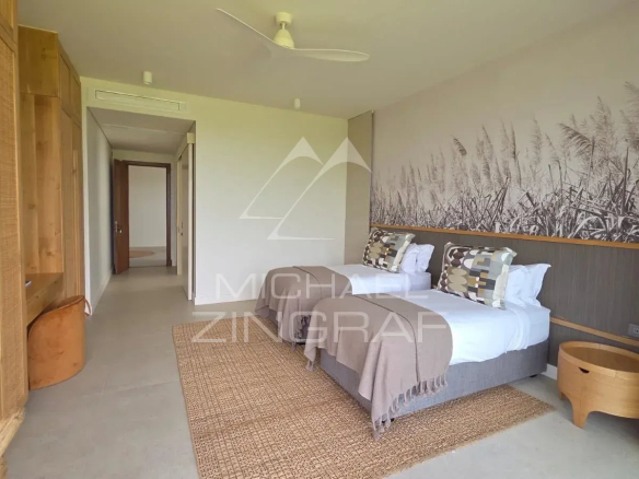 Room in a modern villa with twin beds and contemporary decor.