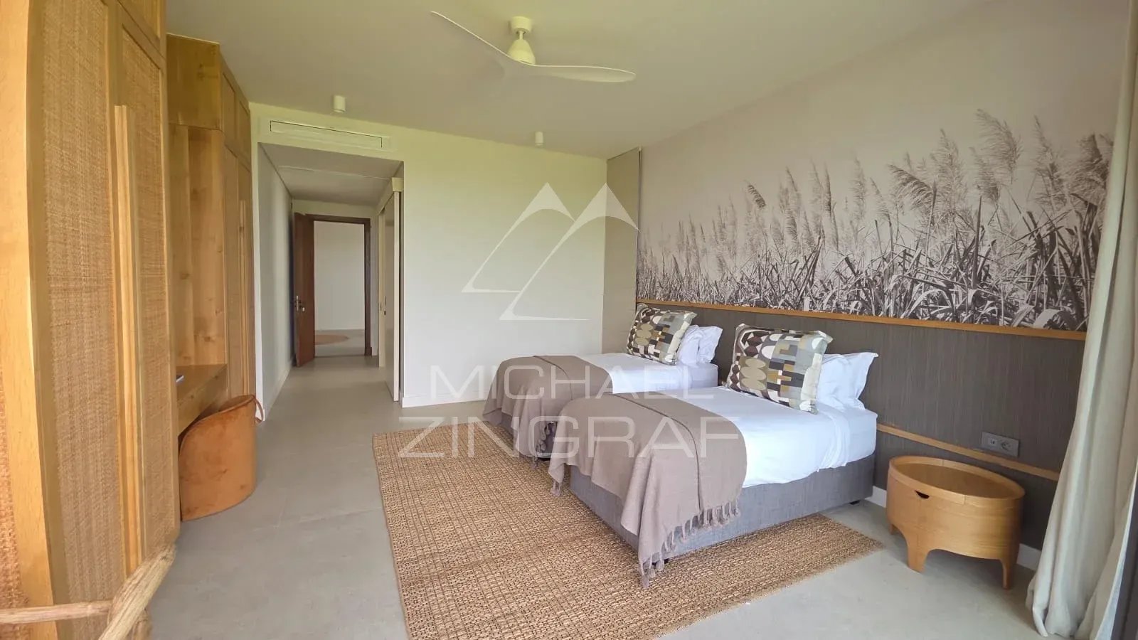 Room in a modern villa with twin beds and contemporary decor.