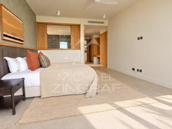 Bedroom in a contemporary villa with a bed and minimalist decor.