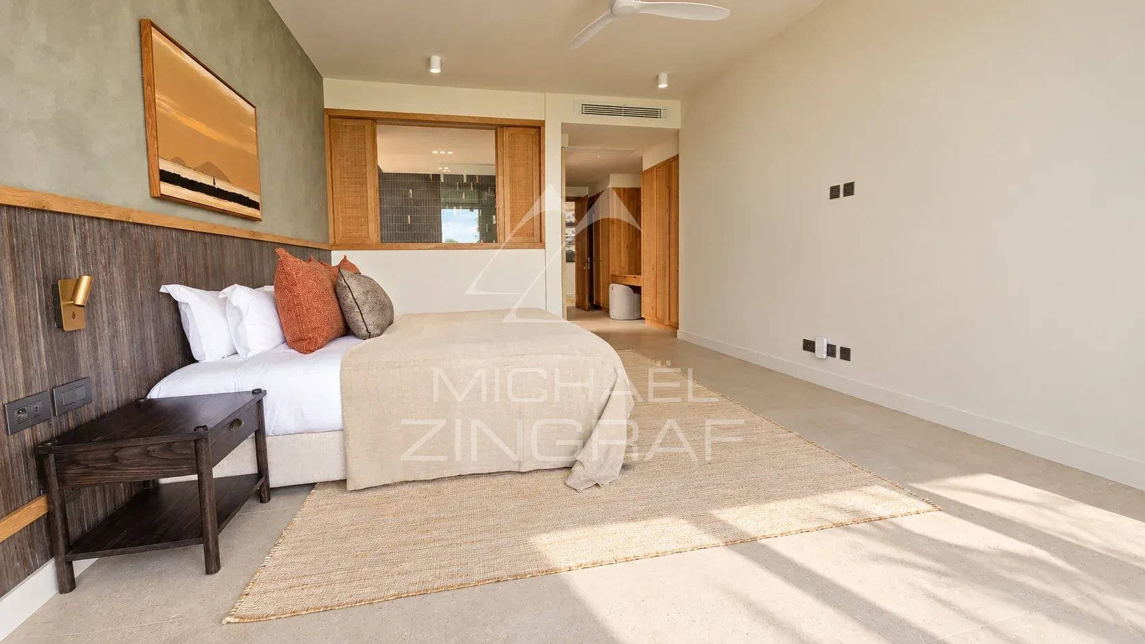 Bedroom in a contemporary villa with a bed and minimalist decor.