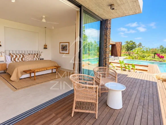 Room in a modern villa overlooking the private pool and tropical garden.