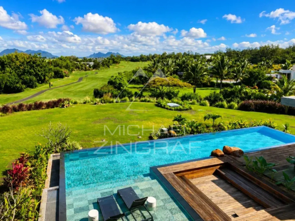Modern villa with infinity pool and golf course views, surrounded by greenery in Beau Champ.