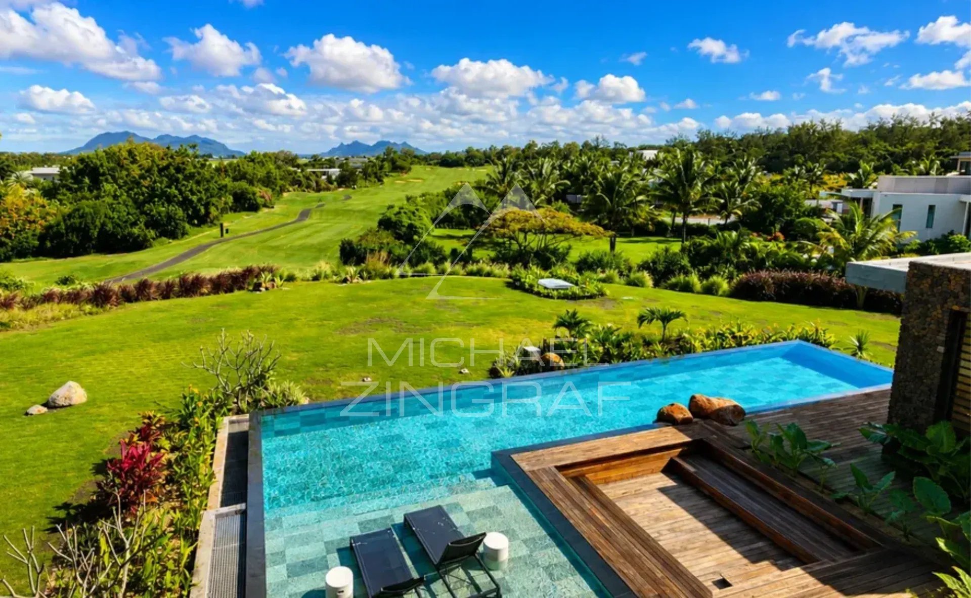 Modern villa with infinity pool and golf course views, surrounded by greenery in Beau Champ.