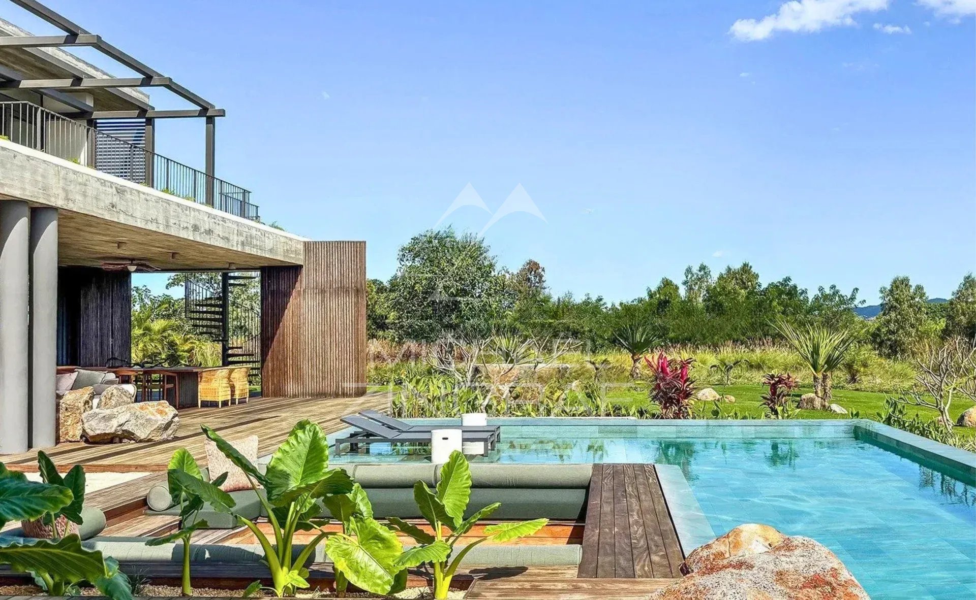 Modern villa with private pool and lush garden, located in the Anahita estate in Beau Champ.