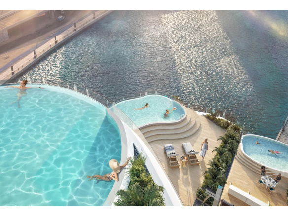 Vue aérienne d'une piscine privative avec plusieurs bassins et chaises longues à Dubaï.