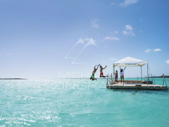 People jumping from a platform into the turquoise water