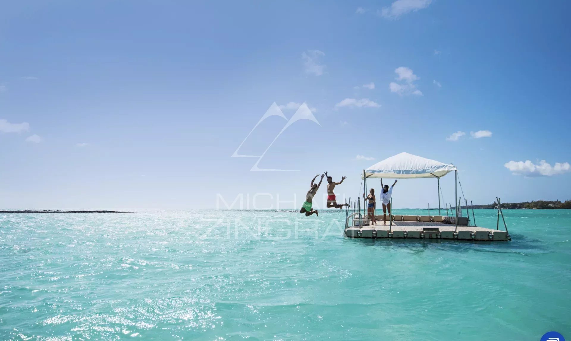 People jumping from a platform into the turquoise water