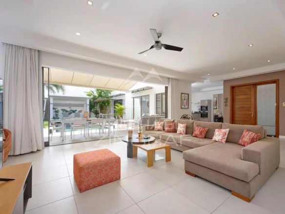 Intérieur d'une villa contemporaine avec salon spacieux et accès à la piscine.