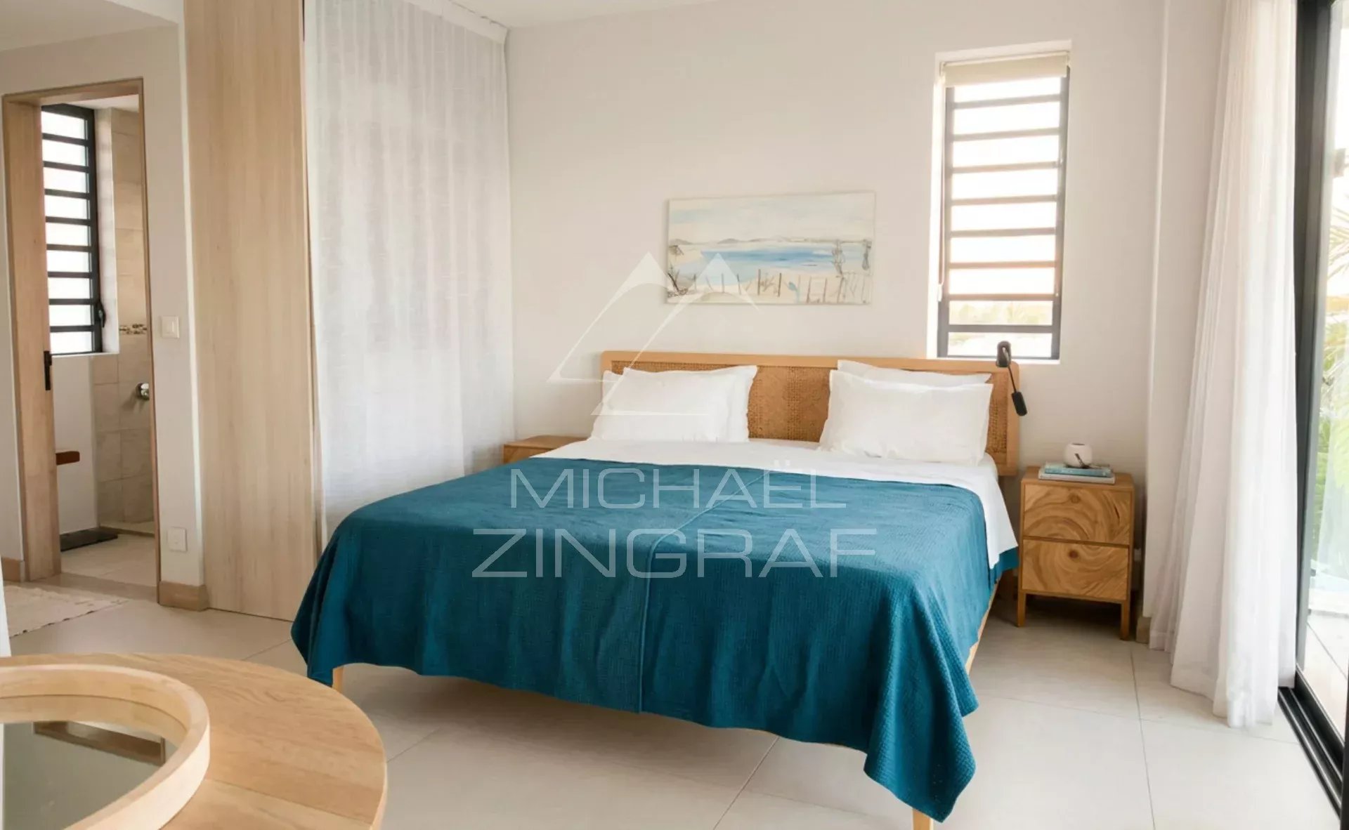 Penthouse bedroom at Pointe aux Canonniers Penthouse bedroom with double bed and window overlooking the outside.