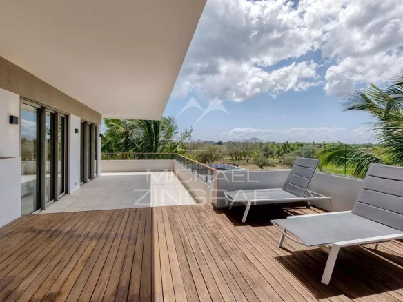 Terrace of a contemporary penthouse with sun loungers and golf course views in Mont Choisy, Grand Baie.