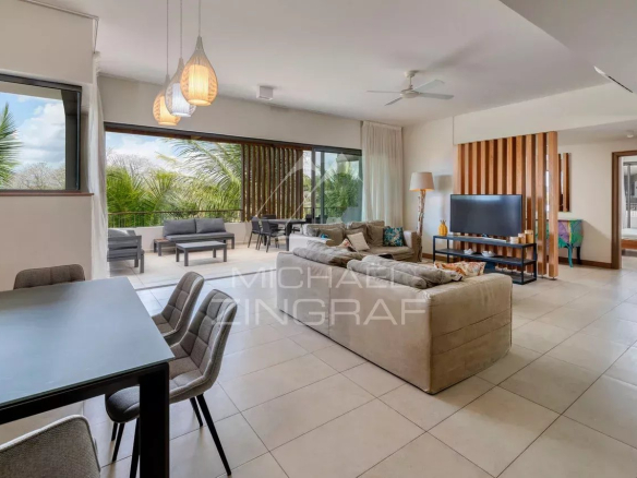 Interior of a modern penthouse with views of nature, spacious living room and contemporary furniture.