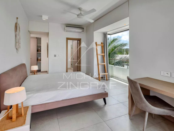 Bedroom in a contemporary penthouse with views of the outside, modern furniture and natural lighting.