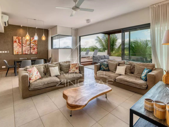 Interior of a contemporary penthouse with views of nature, bright living room and modern furniture.