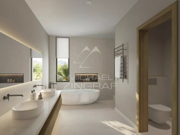 Salle de bain moderne avec baignoire et double vasque dans un appartement.
