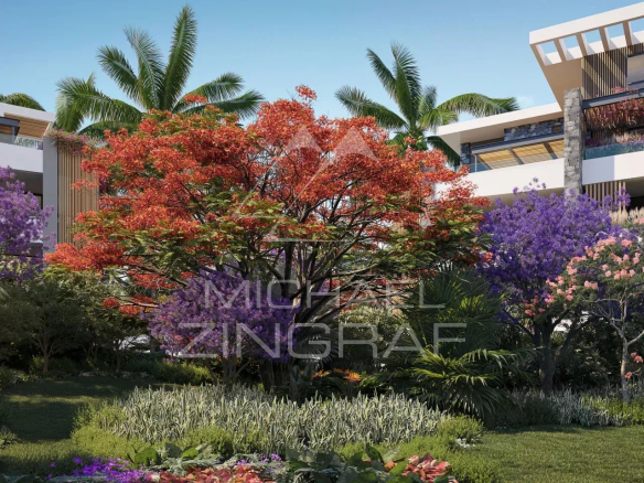Jardin tropical luxuriant avec des fleurs colorées et des palmiers, entourant des bâtiments modernes.