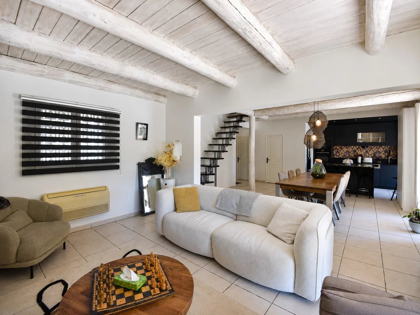 Intérieur d'une villa à Bagnols-en-Forêt avec salon, salle à manger et cuisine ouverte.
