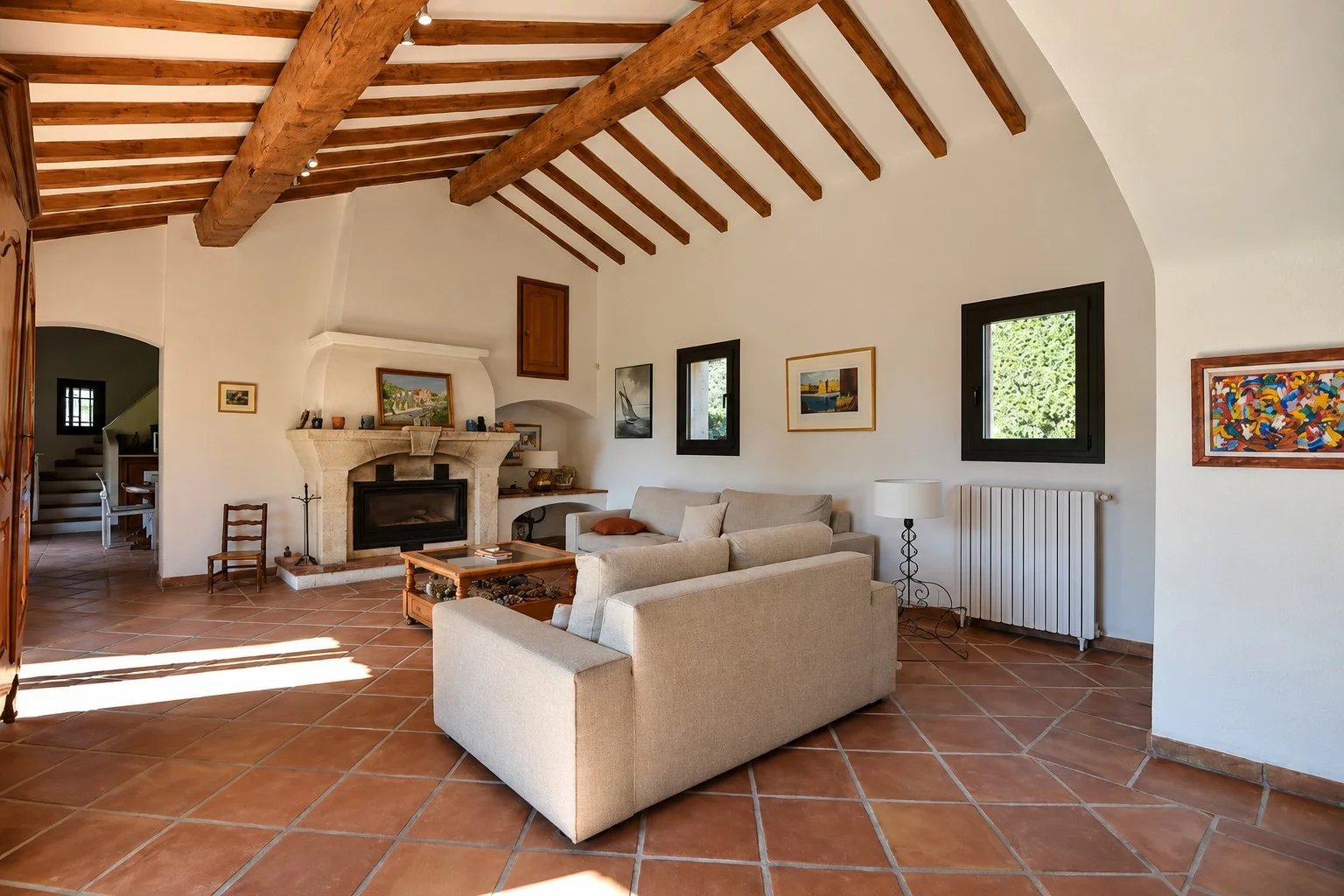 Living room of a Provençal property in Callian Interior of a Provençal property with a bright living room and fireplace.