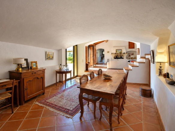 Interior of a Provençal property with dining room, wooden table and authentic decoration.