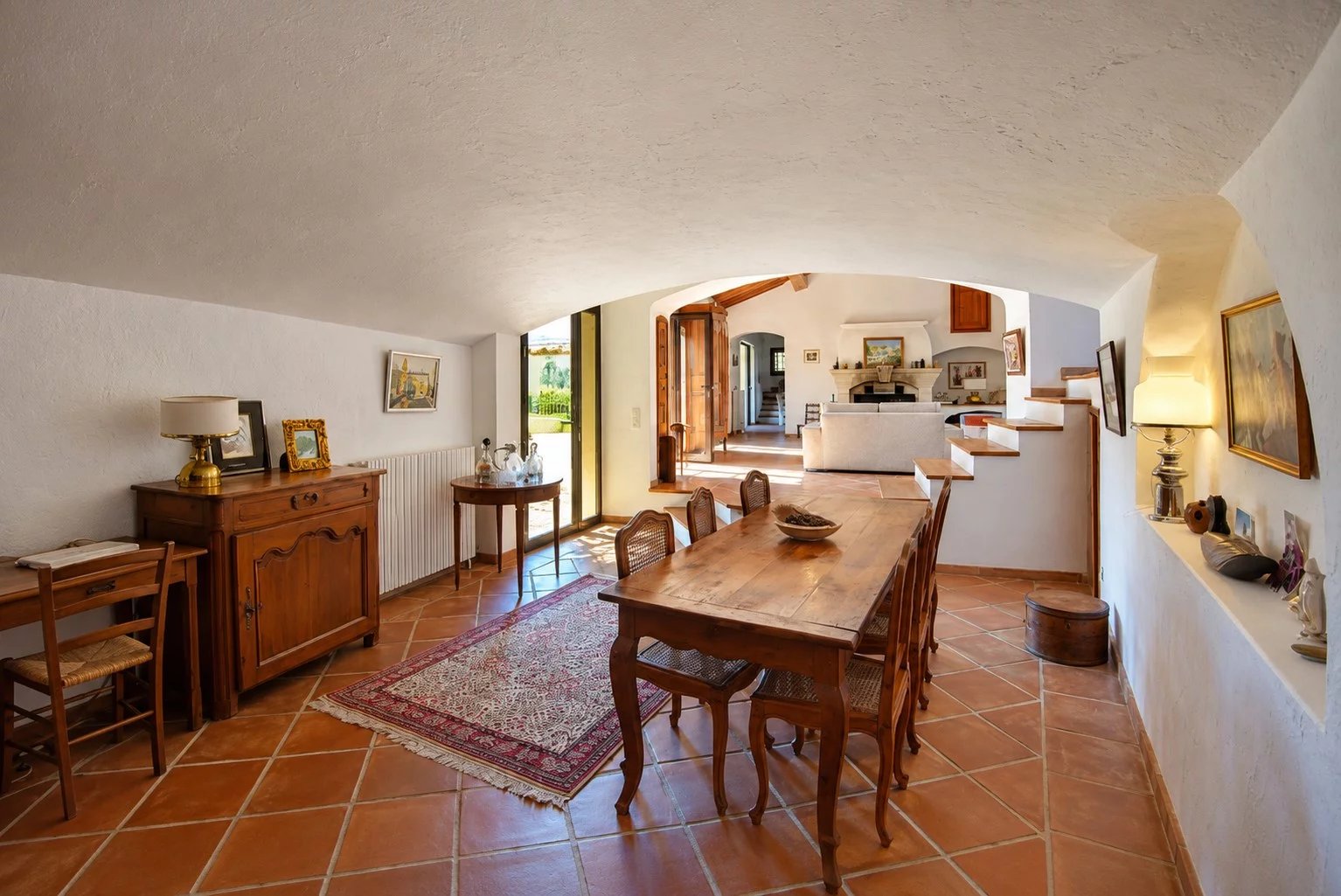Interior of a Provençal property Interior of a Provençal property with dining room, wooden table and authentic decoration.