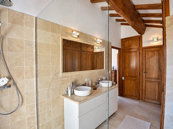 Modern bathroom with walk-in shower and wooden furniture in Callian