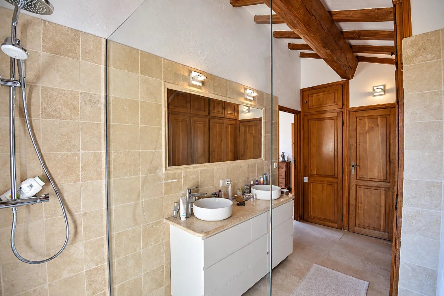 Bathroom in a Provençal property Modern bathroom with walk-in shower and wooden furniture in Callian