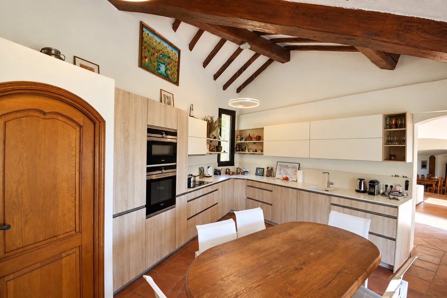 Kitchen of the property in Callian Modern kitchen with wooden table and beamed ceiling in a property in Callian.